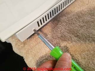 Inserting retaining screws in the Jenn-air outer oven door glass frame (C) Daniel Friedman at InspectApedia.com