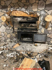 Fire in log wall around retrofit wall unit (C) InspectApedia.com JFKjr