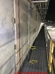 Rigid or IMC metal conduit runs off of wall and down through catwalk (C) Inspectapedia.com Jsse Trelles