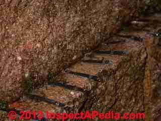 Retaining wall damage © D Friedman at InspectApedia.com 