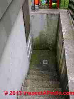 Debris and leaves easily clog this basement walkout stairwell drain (C) Daniel Friedman