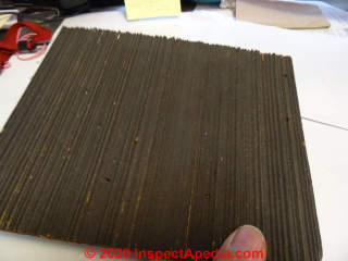 Brushed wood cedar shingle siding bonded to a fiberboard backer (C) InspectApedia.com SmallwoodK