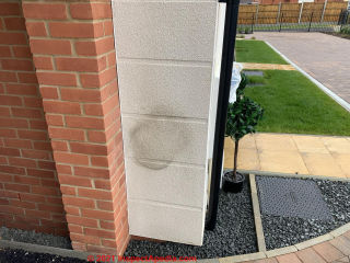 Stain on new stucco exterior faux block (C) InspectApedia.com Amy