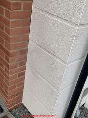 Stain on new stucco exterior faux block (C) InspectApedia.com Amy