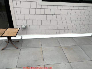 water leak on exterior stone wall of patio (C) InspectApedia.com Alex