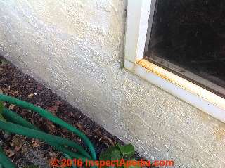 Yellow pollen stains  on exterior stucco from nearby Hibiscus flowers  (C) InspectApedia GC