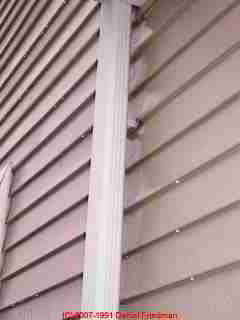 Photograph of leaks down a vinyl-sided building.