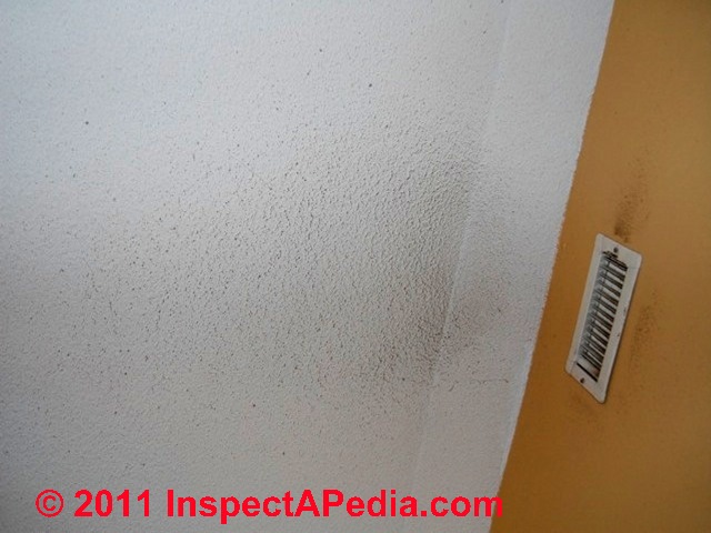 Dust and dirt stains on a ceiling around an air supply register © D Friedman at InspectApedia.com 