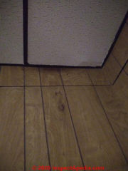 Modern paneling may cover asbestos-containing plasterboard (or other wall surfaces - (C) InspectApedia.com Harris