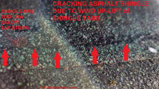 Roof shingle cracked by wind uplift (C) Daniel Friedman at InspectApedia.com